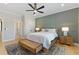 Cozy bedroom features a paneled wall, ceiling fan, and light wood floors at 2989 Waterford Dr, Conyers, GA 30094