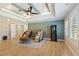 Spacious bonus room with high tray ceilings, hardwoods, massage chairs, and modern mini-fridge at 2989 Waterford Dr, Conyers, GA 30094