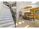 Elegant dining room with modern light fixture adjacent to staircase and views to living area at 2989 Waterford Dr, Conyers, GA 30094
