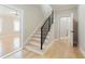 Foyer with hardwood floors, staircase with modern railing, white doors, and access to the living spaces at 2989 Waterford Dr, Conyers, GA 30094