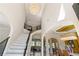 Grand foyer featuring a staircase, chandelier, and views into dining and living areas at 2989 Waterford Dr, Conyers, GA 30094
