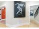 Hallway with modern art, hardwood floors, neutral paint, and access to the rest of the home at 2989 Waterford Dr, Conyers, GA 30094