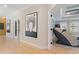 Hallway with artwork leads to a living room with a tray ceiling and lots of natural light at 2989 Waterford Dr, Conyers, GA 30094
