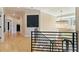 Upstairs hallway boasts hardwood floors, elegant chandelier, and natural light at 2989 Waterford Dr, Conyers, GA 30094