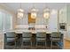 Modern kitchen featuring island seating, designer lighting and stainless appliances at 2989 Waterford Dr, Conyers, GA 30094