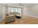 Living room features an open floor plan, hardwood floors, and a comfortable sectional sofa at 2989 Waterford Dr, Conyers, GA 30094