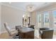 The office is lit by a modern light fixture and has views to the exterior of the property at 2989 Waterford Dr, Conyers, GA 30094