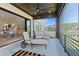 Relaxing screened-in patio featuring comfortable lounge chairs, a ceiling fan, and views of the serene backyard at 2989 Waterford Dr, Conyers, GA 30094