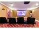 Comfortable theater room with tiered seating and a large screen for an immersive viewing experience at 2989 Waterford Dr, Conyers, GA 30094