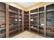 Custom walk-in closet with built-in shelves and hardwood floors at 2989 Waterford Dr, Conyers, GA 30094