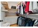 Organized walk-in closet with wood shelves, cabinets, rod for hanging clothes, and space for storage at 2989 Waterford Dr, Conyers, GA 30094
