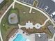 Aerial view of a community playground, fire pit, pool and seating area at 3604 Silvery Way, Powder Springs, GA 30127