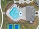 Aerial view of a community pool and clubhouse area with tennis courts nearby at 3604 Silvery Way, Powder Springs, GA 30127