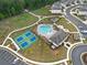 Aerial view of community amenities featuring a pool, tennis courts, and green spaces at 3604 Silvery Way, Powder Springs, GA 30127