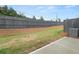 Landscaped backyard with a wood fence and an air conditioning condenser at 3604 Silvery Way, Powder Springs, GA 30127