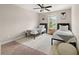 Cozy bedroom with neutral walls, a ceiling fan, and two twin beds on a patterned rug at 3604 Silvery Way, Powder Springs, GA 30127