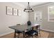 Dining area with a rustic table, comfortable seating, and modern decor at 3604 Silvery Way, Powder Springs, GA 30127