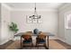 A dining area with a table, chairs, artwork, and a chandelier, offering a cozy space for meals at 3604 Silvery Way, Powder Springs, GA 30127