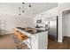 Modern kitchen featuring an island with bar seating, pendant lighting, stainless steel appliances, and white cabinetry at 3604 Silvery Way, Powder Springs, GA 30127