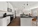 Modern kitchen with stainless steel appliances, white cabinets, and a black countertop island at 3604 Silvery Way, Powder Springs, GA 30127