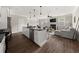 Open concept living room with a fireplace, island kitchen, and hardwood floors at 3604 Silvery Way, Powder Springs, GA 30127