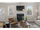 Cozy living room featuring a fireplace, comfortable seating, and natural light at 3604 Silvery Way, Powder Springs, GA 30127