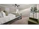 Main bedroom with a bed, ceiling fan, natural light, and neutral décor creating a relaxing retreat at 3604 Silvery Way, Powder Springs, GA 30127