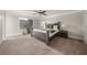 Spacious main bedroom with a large bed, ceiling fan, natural light, and neutral décor creating a relaxing retreat at 3604 Silvery Way, Powder Springs, GA 30127