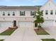 Charming townhomes featuring attached garages and a mix of brick and siding exteriors at 3604 Silvery Way, Powder Springs, GA 30127