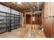 Unfinished basement featuring exposed wood framing, ductwork, metal shelving, and concrete floors, ready for customization at 1855 Vintage Dr, Snellville, GA 30078