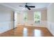 A bedroom with hardwood floors, ceiling fan, and natural light from the windows at 1855 Vintage Dr, Snellville, GA 30078