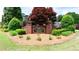 Charming brick entrance to Williams Place with lush landscaping and mature trees around the sign at 1855 Vintage Dr, Snellville, GA 30078