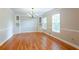 Dining room with hardwood floors, chandelier, built in shelving, and multiple windows at 1855 Vintage Dr, Snellville, GA 30078