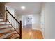Hardwood floor entryway with stairs and an open dining room at 1855 Vintage Dr, Snellville, GA 30078