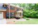 Traditional brick home featuring a two-car garage, well-manicured lawn, and a classic design at 1855 Vintage Dr, Snellville, GA 30078