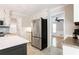 Stainless refrigerator in a kitchen with an island and opening to a living room at 1855 Vintage Dr, Snellville, GA 30078