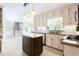 Kitchen with a center island, stainless appliances, view of entry stairs and abundant light at 1855 Vintage Dr, Snellville, GA 30078