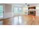 Living room with hardwood floors, fireplace, bay window, and access to back porch at 1855 Vintage Dr, Snellville, GA 30078