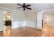 Living room with hardwood floors, ceiling fan, and white wainscoting and trim at 1855 Vintage Dr, Snellville, GA 30078