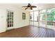 Screened-in patio with a ceiling fan, wooden floor and walls, and access to the backyard at 1855 Vintage Dr, Snellville, GA 30078