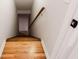 View of wooden stairs leading to the basement with a wood handrail and white walls at 1855 Vintage Dr, Snellville, GA 30078