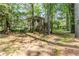 The home's private backyard features mature trees and a chain-link fence at 2586 Williamsburg Dr, Decatur, GA 30034
