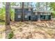 The backyard featuring the house and deck, showing mature trees and lawn at 2586 Williamsburg Dr, Decatur, GA 30034