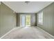 Bedroom with plush carpet and window providing natural light and view of outside at 2586 Williamsburg Dr, Decatur, GA 30034
