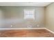 Empty living room with neutral walls, hardwood floors, and a window at 2586 Williamsburg Dr, Decatur, GA 30034