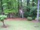 Large backyard featuring mature trees and lush green grass at 2795 Dodson Lee Dr, East Point, GA 30344