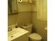 Bathroom with tiled walls, a vanity sink, and a toilet; window provides natural light at 2795 Dodson Lee Dr, East Point, GA 30344