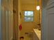 Small, charming bathroom features white fixtures, a window, and neutral decor at 2795 Dodson Lee Dr, East Point, GA 30344