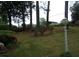 Manicured front lawn with mature trees, a decorative light post, and flowering bushes at 2795 Dodson Lee Dr, East Point, GA 30344