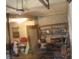 A cluttered garage with block walls, shelving, and a garage door opener at 2795 Dodson Lee Dr, East Point, GA 30344